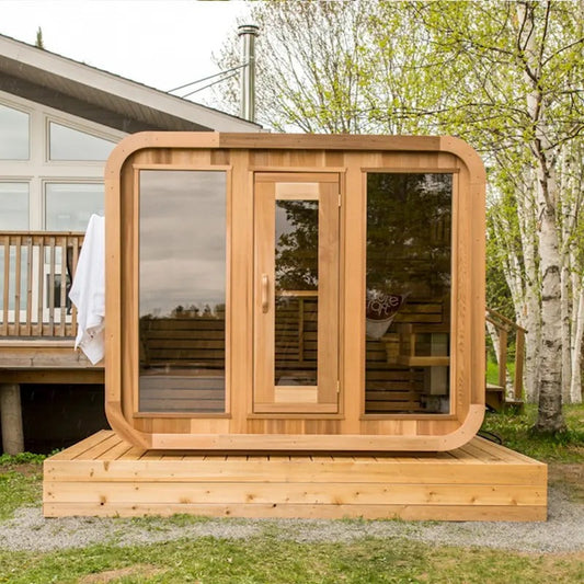 The Cube outdoor wood-fired sauna installed on a deck, chimney visible