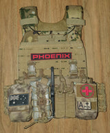 Tactical plate carrier vest with weight plates laid out